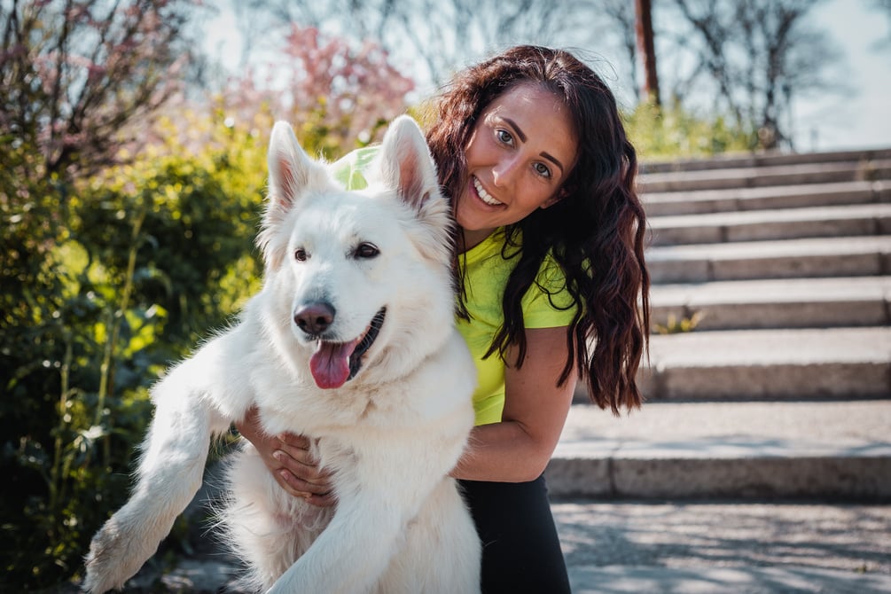 Happy owner and her white dog